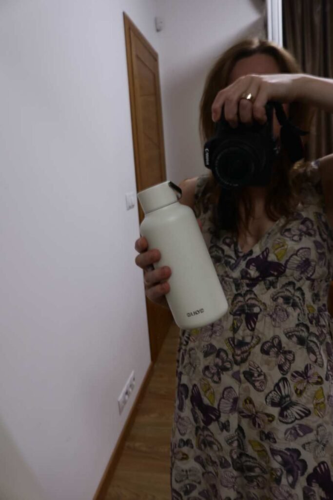 EQUA reusable bottle in cream white held in hand – eco-friendly daily hydration habit