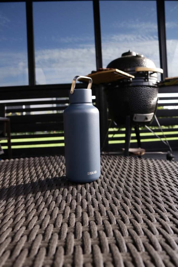 EQUA stainless steel reusable bottle in matte blue – eco-friendly hydration lifestyle outdoors