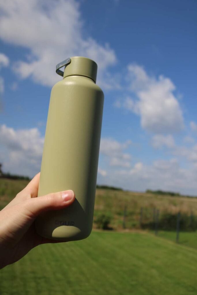 EQUA stainless steel reusable bottle in matcha – eco-friendly hydration outdoors in nature