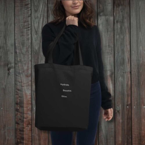 hydrate-breathe-glow-eco-tote-women-holding