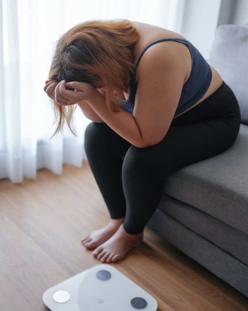 Woman frustrated on scale – sugary drinks linked to weight gain