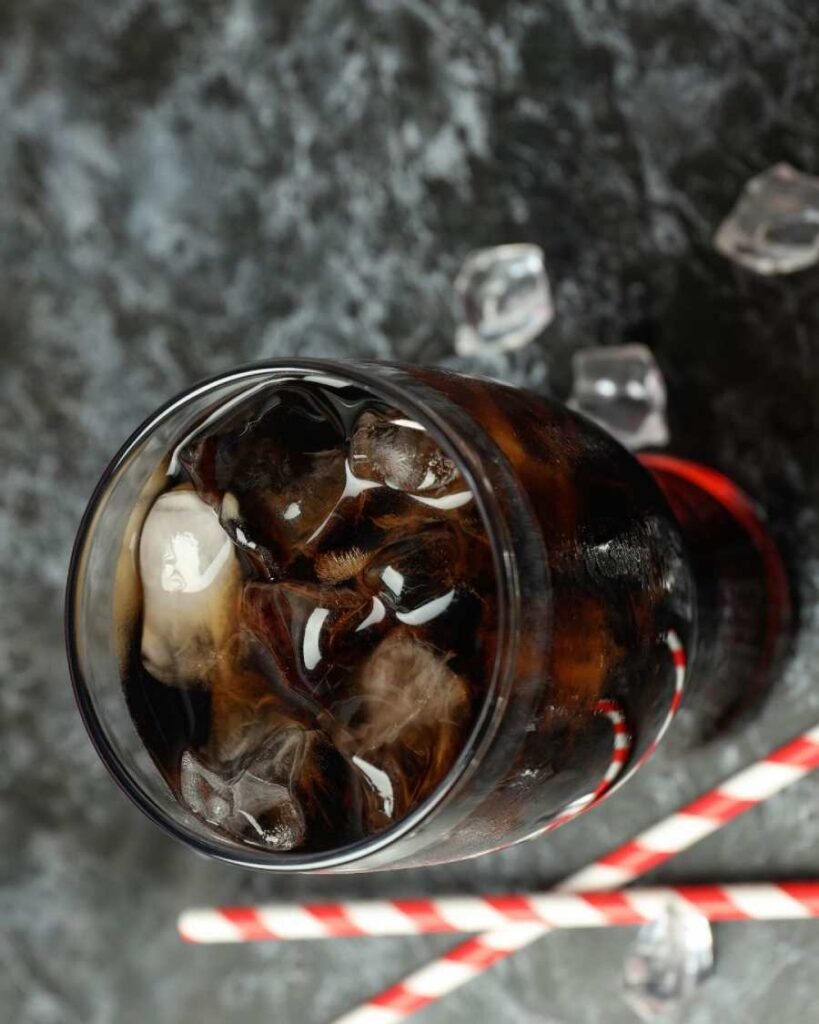 Glass of sugary soda with ice – empty calories harming hydration